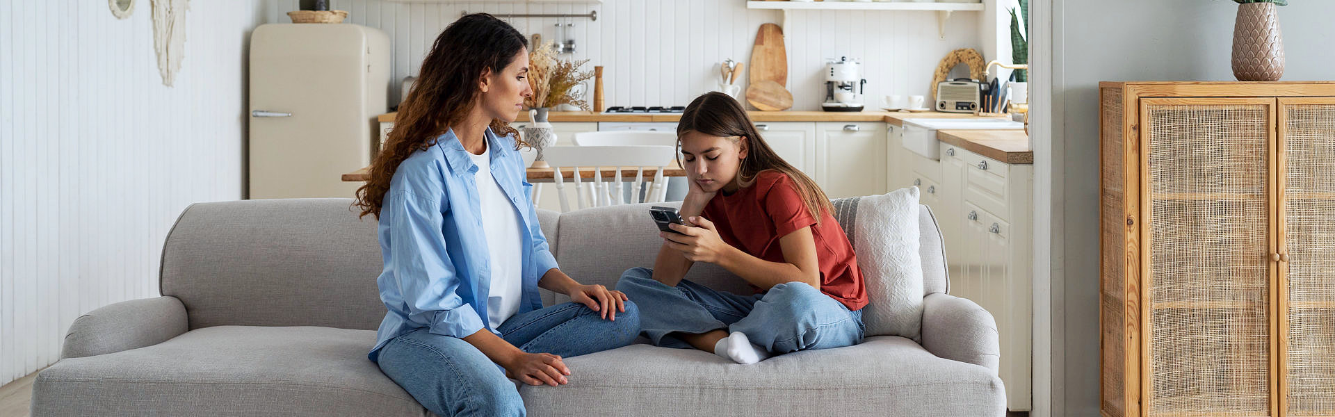 Two person sitting down in a couch
